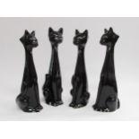 Four large 1950's vintage kitsch black pottery cats. Tallest 34cm