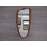 A Mid Century teak backed shaped wall mirror. Overall size 79cm x 36cm