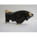 A Trentham black/gold bull designed by Colin Melborne. 29cm long x 15cm high