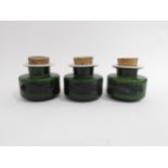Three Holmegaard cased green glass spice jars with cork lids. 7cm high without cork.