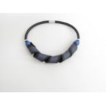 A comtemporary modernist design choker necklace in rubber and metal