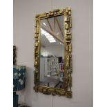 A Syroco brutalist mirror, mark to reverse frame, overall size 107cm x 50cm