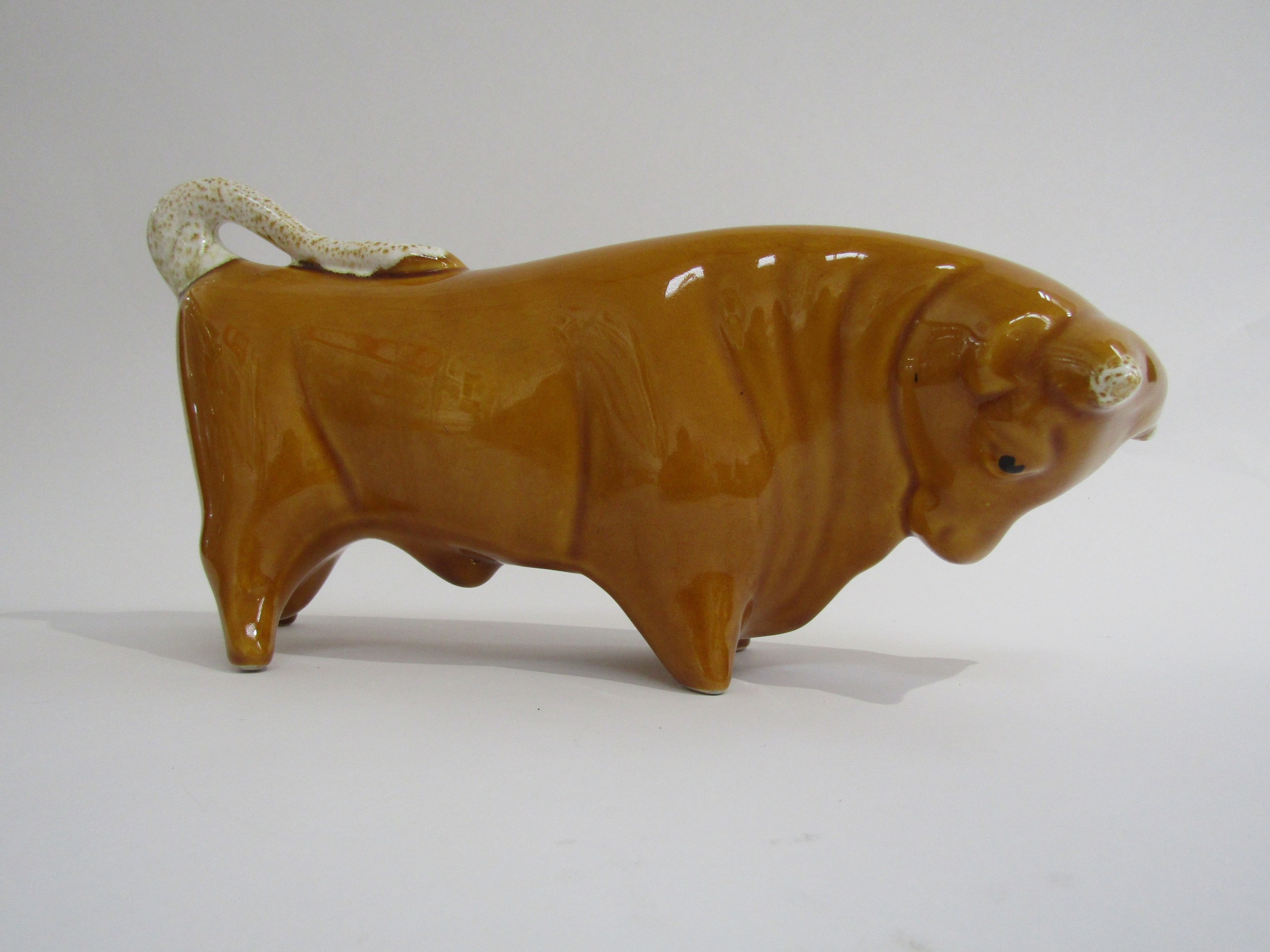 A Trentham bull designed by Colin Melbourne finished in unusual honey colour. 29cm long x 15cm high