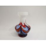 A Murano Carlo Moretti glass vase with mottled swag detail in blues and red on white ground, 23cm