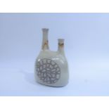 LAURIE SHORT (XX) A studio pottery twin spout bottle vase with impressed motifs centre. Seal to