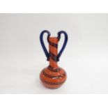 A Lafiore orange and blue glass bottle vase in orange and blue spiral pattern with twin applied