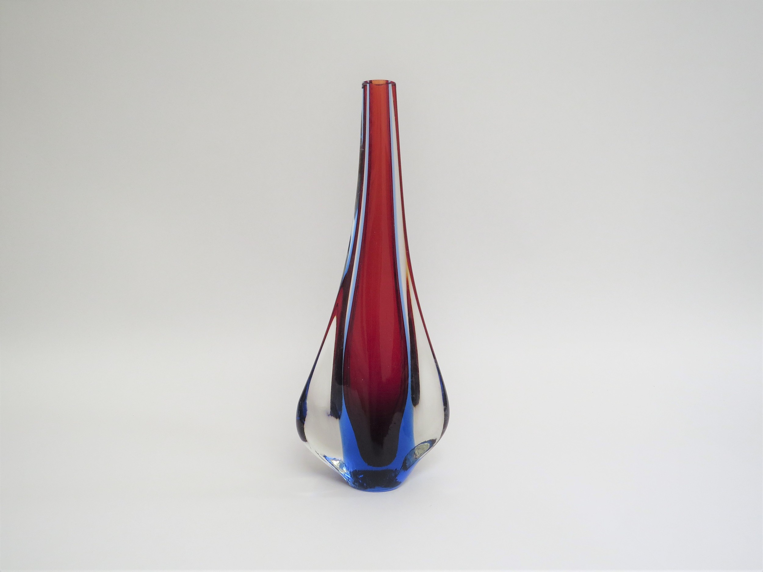 A Murano glass slender vase in red and blue encased in clear with 'fin' sides. 27.5cm high