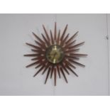 A Starburst wall clock by Ansley & Wilson with teak and brassed finish, 63.5cm diameter