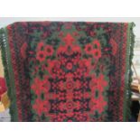 A large Casa Pupo rug in red/green floral design, circa 1970. Approx size 250cm x 200cm