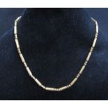 An unmarked gold barrel and ball link necklace, 42cm long, 15.2g
