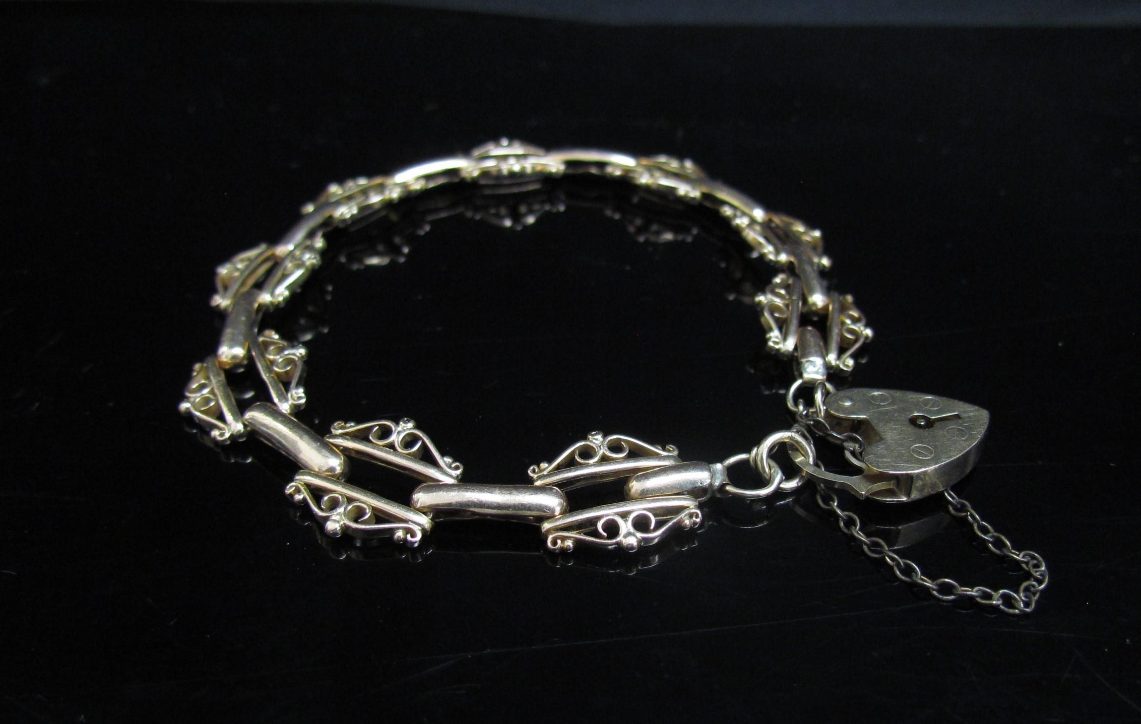 A 9ct gold fancy link bracelet with padlock clasp, 19cm long, 13.6g