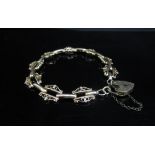 A 9ct gold fancy link bracelet with padlock clasp, 19cm long, 13.6g