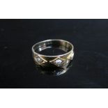 A 15ct gold ring set with three seed pearls. Size O/P, 2.2g