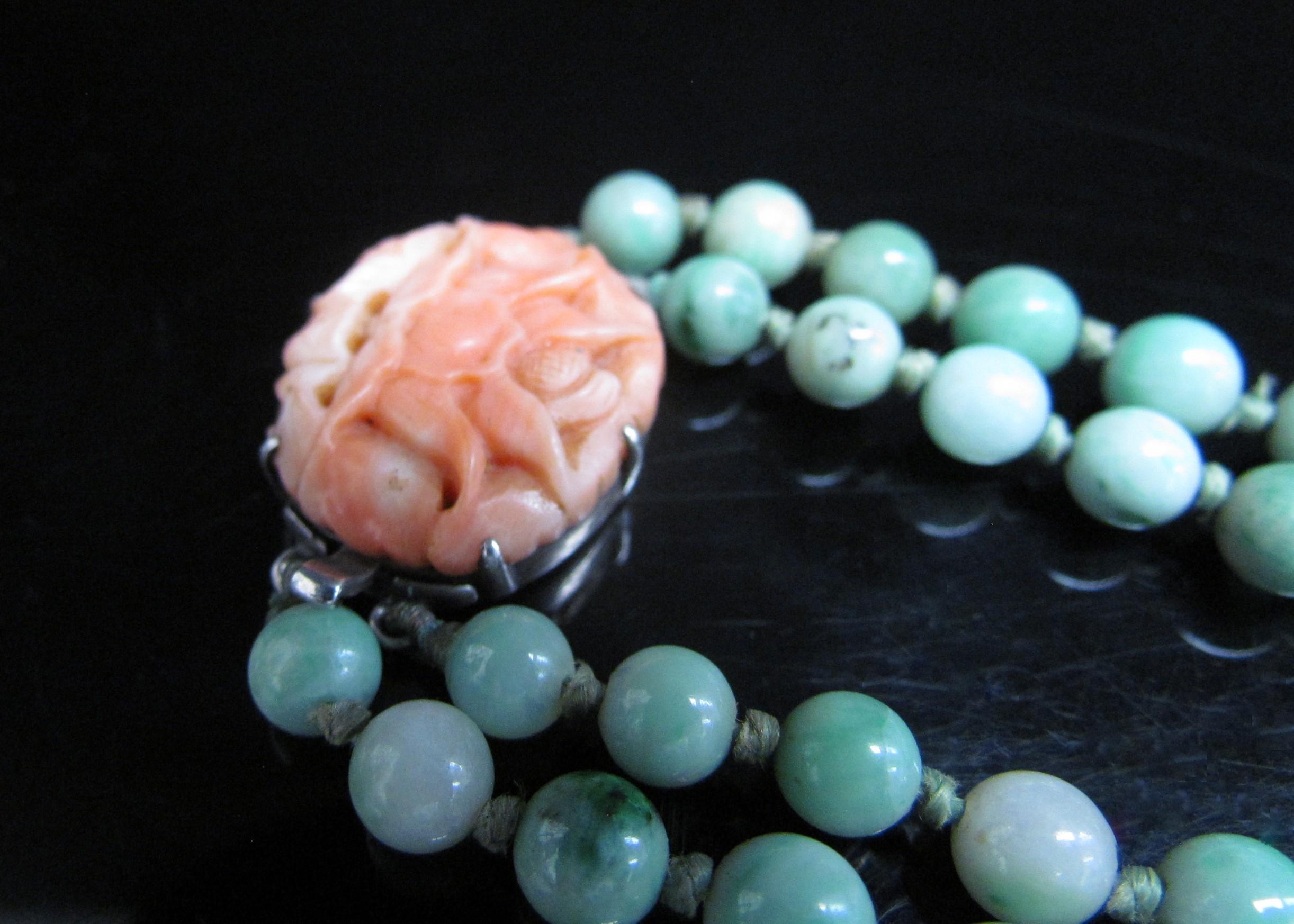 A jade bead necklace with carved coral clasp, 38cm long - Image 2 of 3