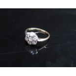 A diamond daisy ring 0.70ct total approx, unmarked gold. Size J, 2.1g