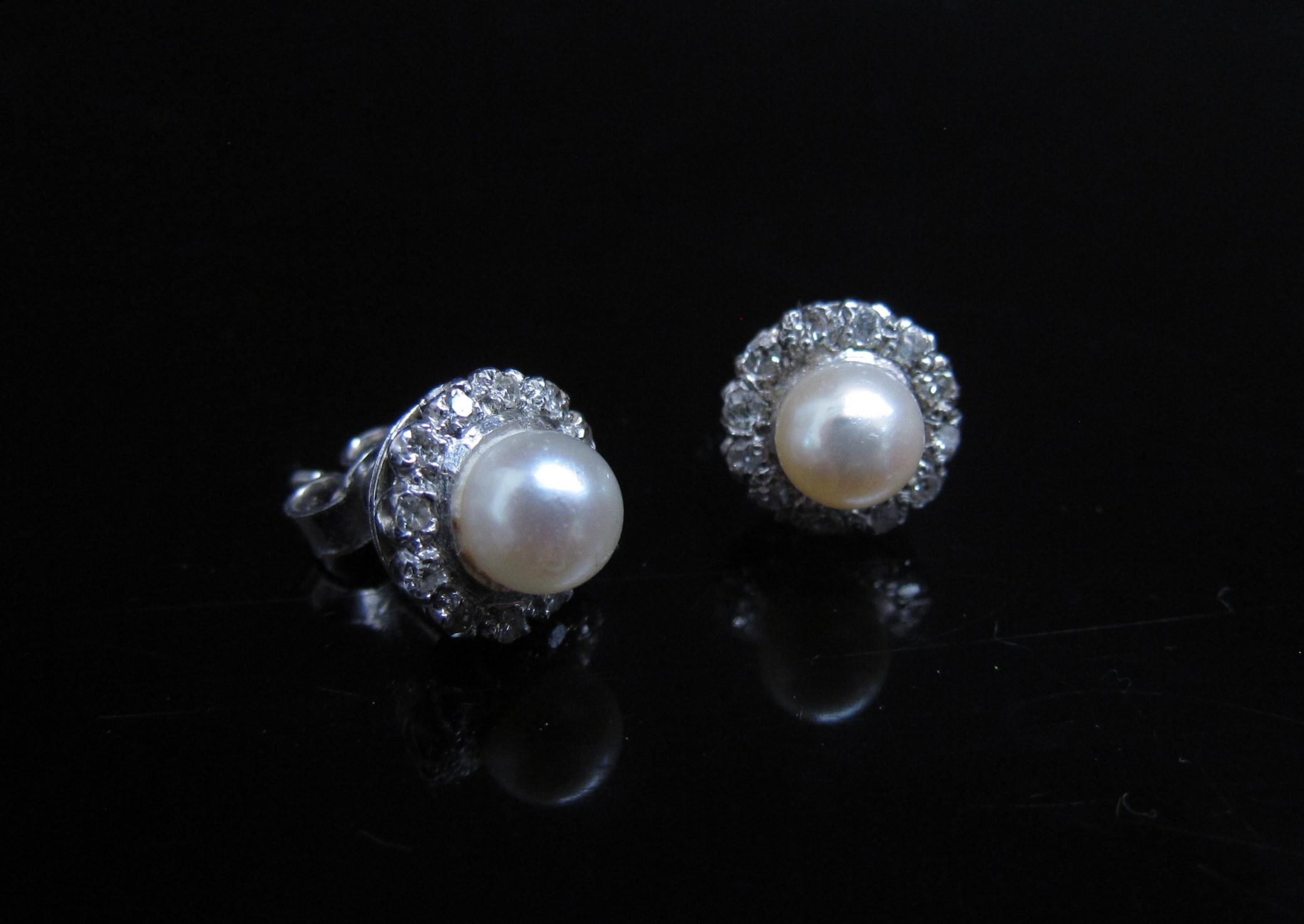 A pair of pearl and diamond earrings, the central pearl 5mm diameter framed by diamonds, for pierced - Image 2 of 3