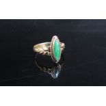 A gold ring set with a jadeite lozenge, stamped 18. Size G, 2.1g