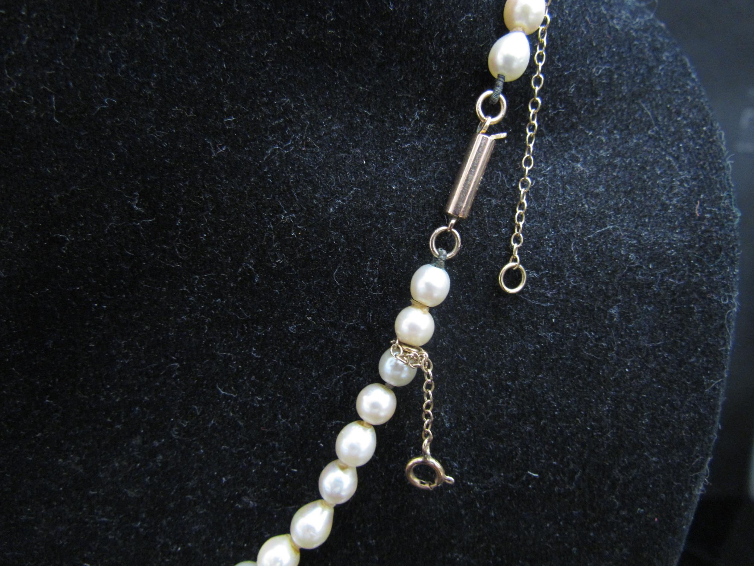 A single strand graduated pearl necklace, 44cm long, clasp stamped 9ct - Image 2 of 3
