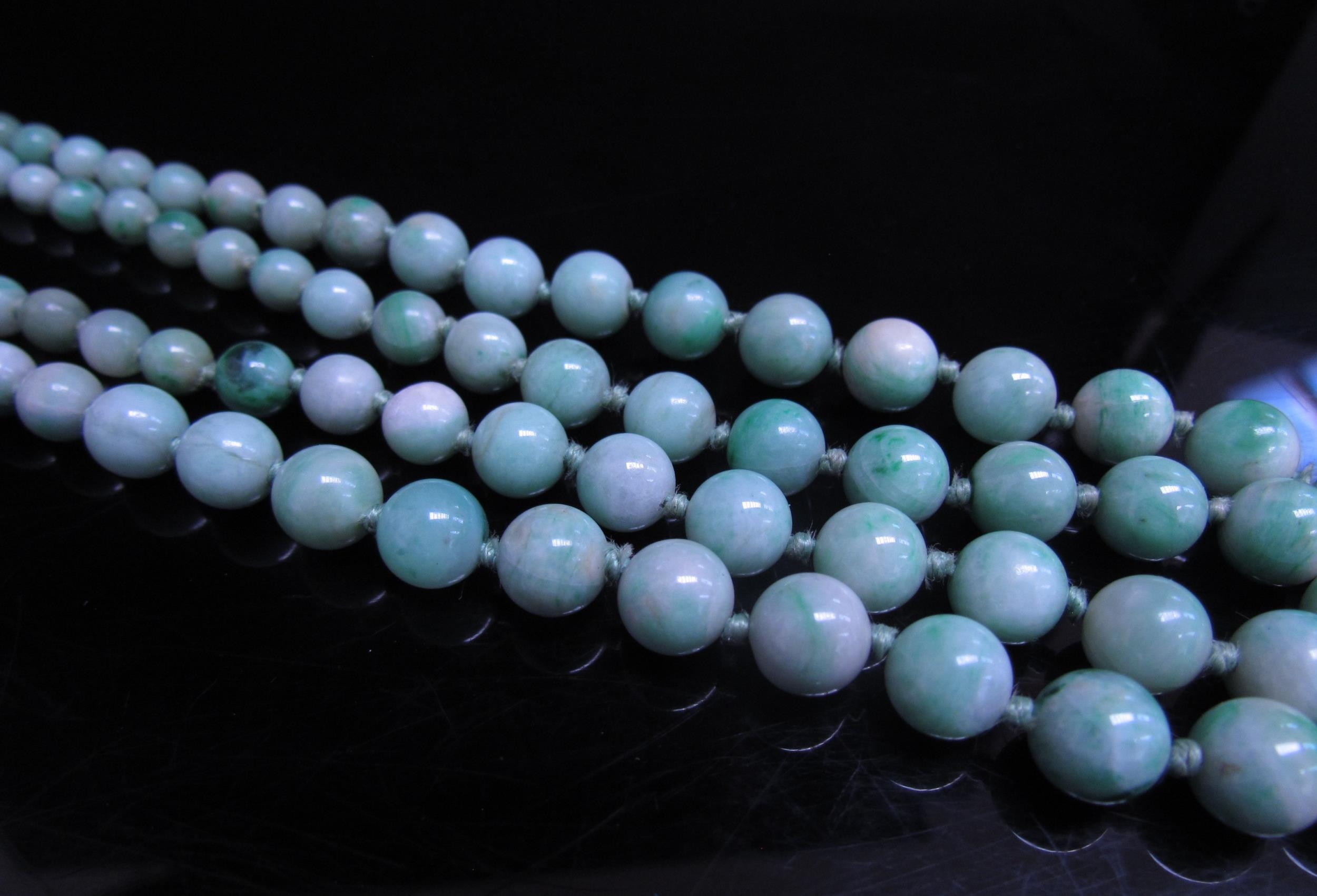 A jade bead necklace with carved coral clasp, 38cm long - Image 3 of 3