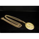 An 18ct gold St Christopher pendant with motor car to reverse, hung on an 18ct gold neckchain,