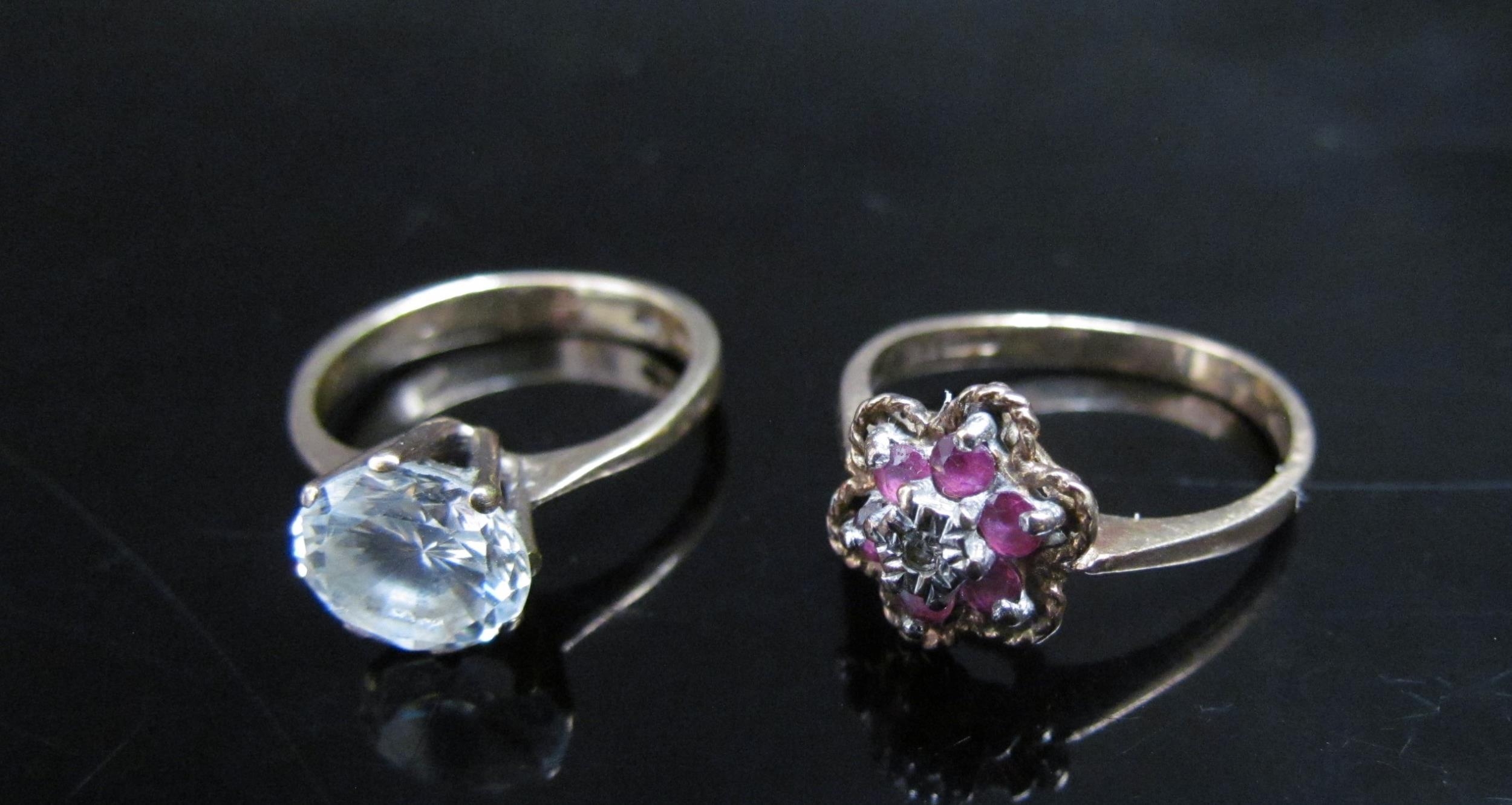 Two 9ct gold rings including ruby and diamond cluster (bent) and a ring set with a clear stone, 4.9g