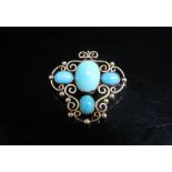 An unmarked gold brooch with four cabochon turquoise, scroll decoration, 6.9g