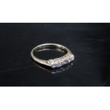 A gold five stone diamond ring marked 18ct, rubbed. Size K, 1.7g