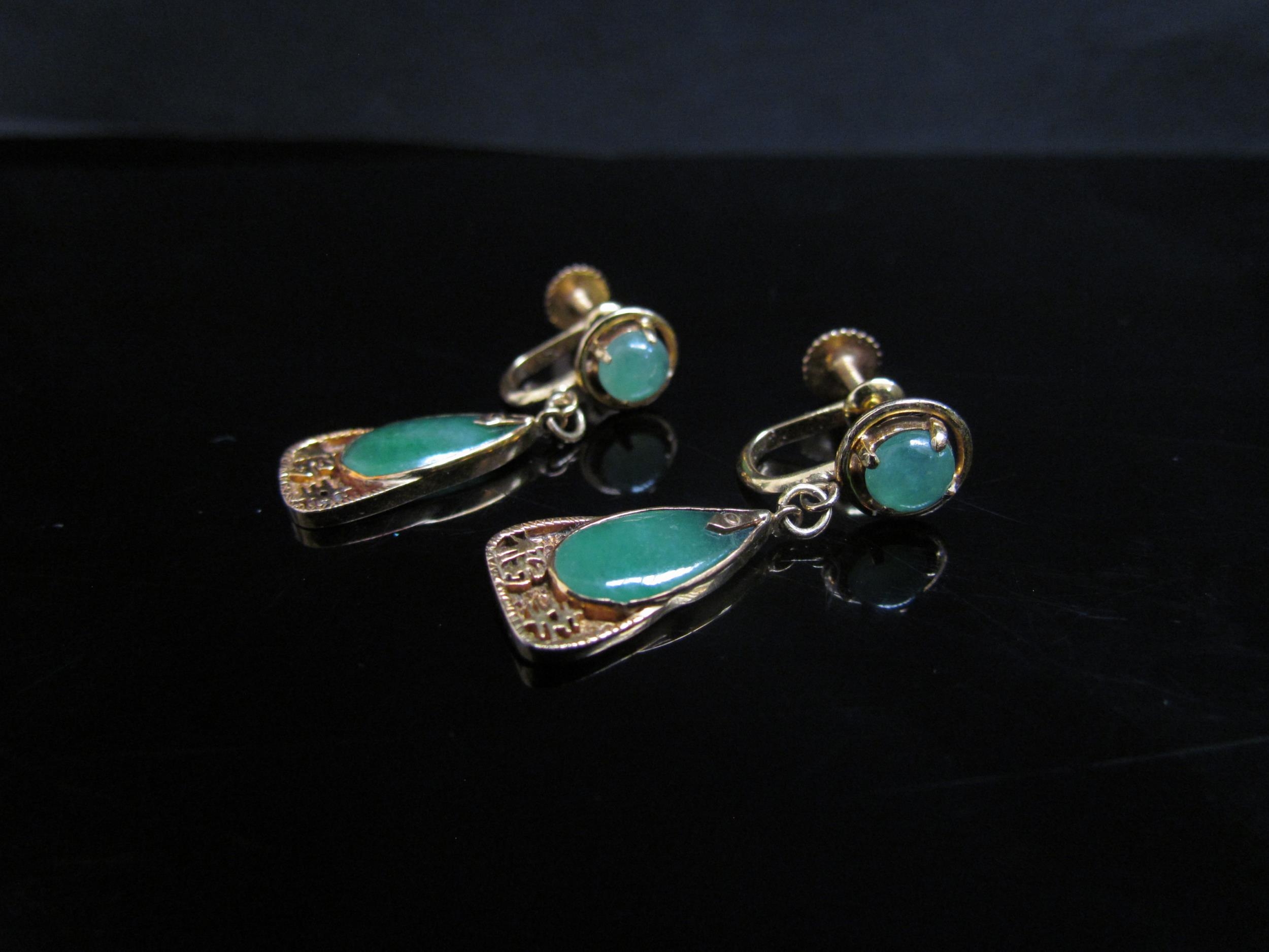 A pair of jadeite drop earrings with Oriental character marks, 3cm drop, stamped 14k, 4.9g