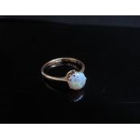 A 22ct gold circular opal cabochon ring. Size O/P, 2.7g