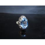 A gold ring set with an oval pale blue stone, stamped 333, 3.7g