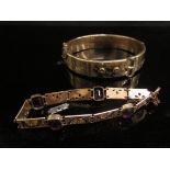 A gold plated stiff hinge bangle and bracelet set with amethyst coloured glass