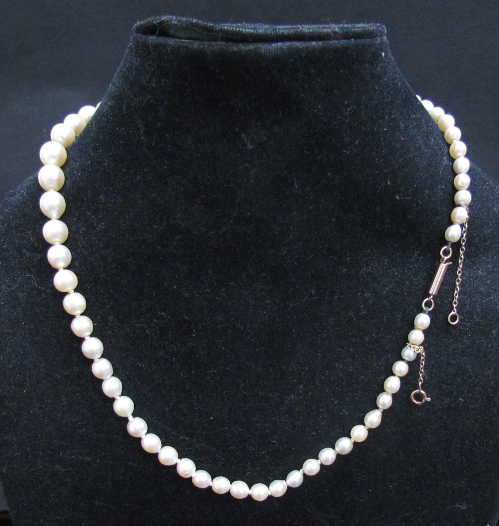 A single strand graduated pearl necklace, 44cm long, clasp stamped 9ct