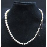 A single strand graduated pearl necklace, 44cm long, clasp stamped 9ct
