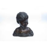 A bronze bust of a smiling young boy, marked 'H. Luppens & Cie' to the shoulder. 30cm high.