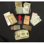 A cash tin containing a German Eastern Front Medal 1941/42 and two WWI German belt buckles (both