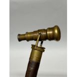 A walking stick with brass telescope top, parts missing and adapted