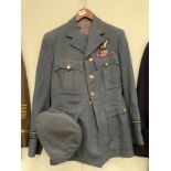 A post war RAF navigator's uniform consisting of jacket, trousers and hats with WWII Polish medal