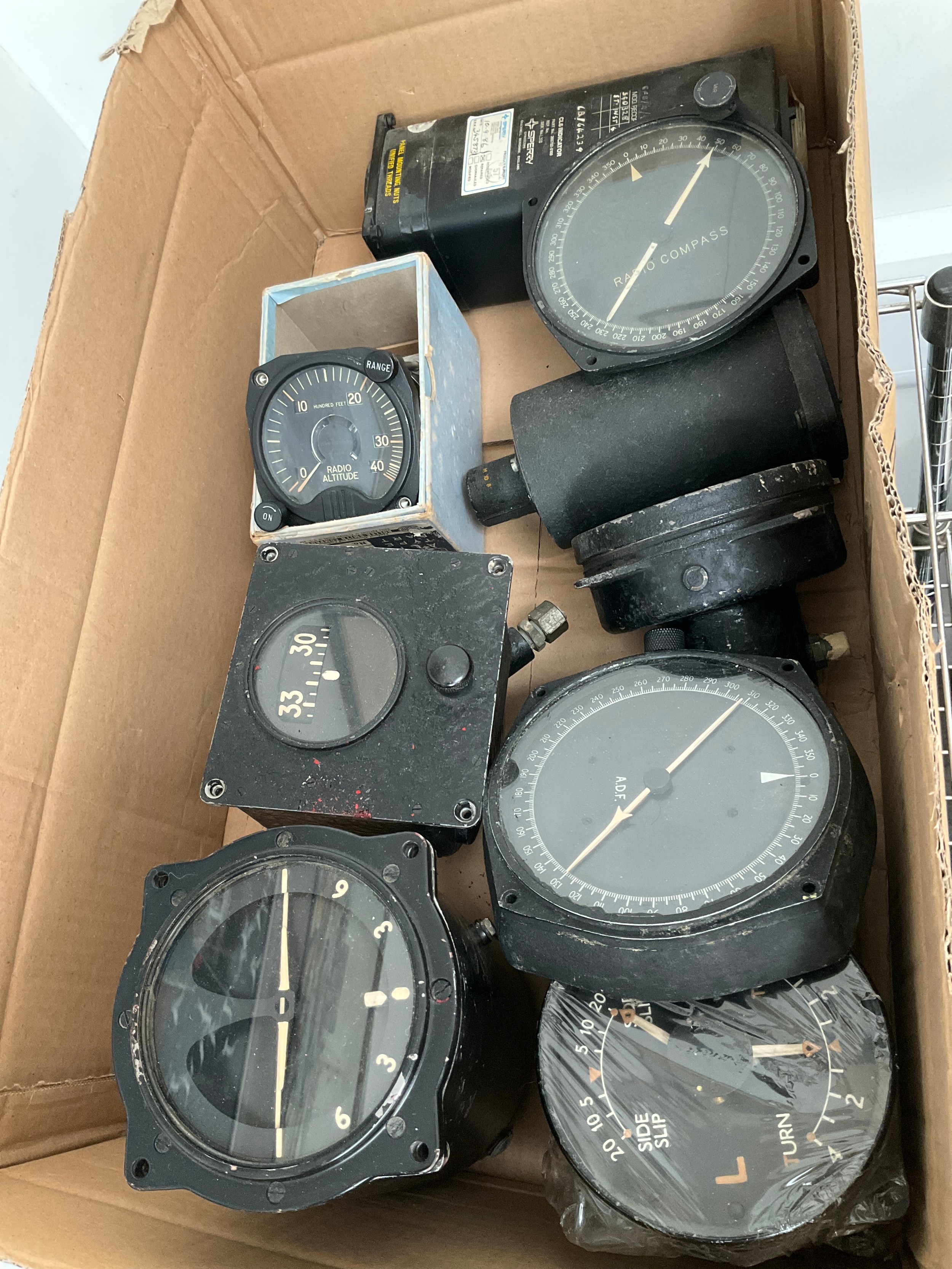 A box of mixed aircraft dials/gauges