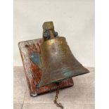 A bronze ship's bell stamped "METAL FROM HMS TIGER, JUTLAND 1916, mounted upon oak plaque, metalwork
