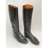 A pair of black leather riding boots