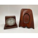 An early 20th Century car clock in wooden stand together with a wooden propeller tip photo frame (2)