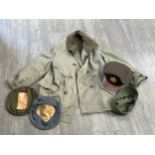 A box of US uniform including Mackinaw jacket, peaked cap and cap covers etc