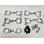 Five pairs of 20th Century handcuffs including Hiatt, together with two police whistles and King's