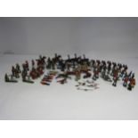 A wooden box containing Britains, John Hill & Co. and other lead figures including mounted and