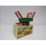 A boxed Britains Farm no. 130F Two Wheel Tipping Trailer With Rubber Tyres, damage to one rack