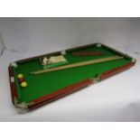 A Joe Davis miniature table top billiards/snooker table with two cues, scorer and rule book, 93cm
