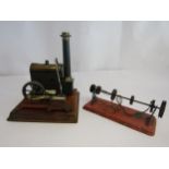 A live steam stationary engine mounted on wooden base (brass boiler a/f), together with a drive
