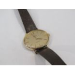 An Omega Geneve gold plated and steel cased manual wind wristwatch of oval form, gilded dial and