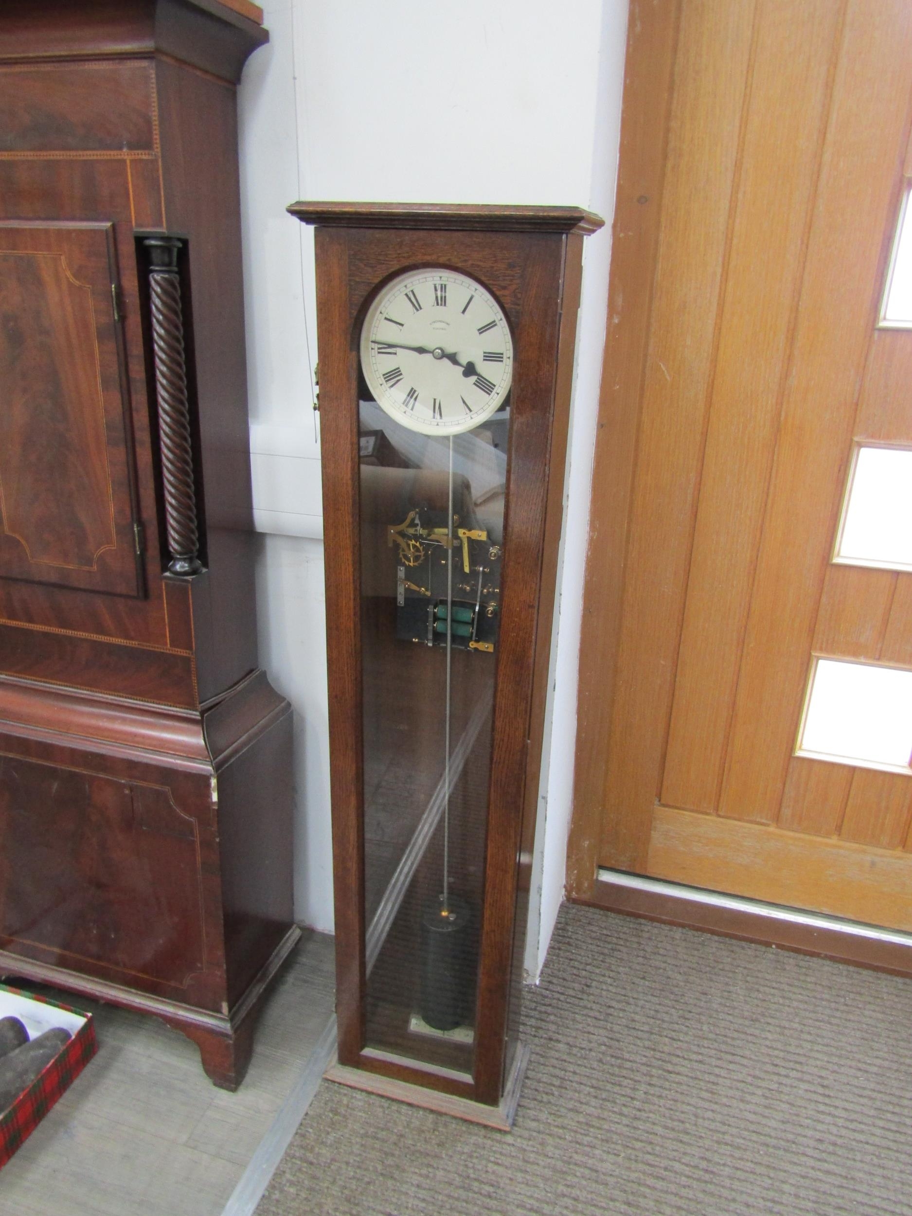 A 20th Century oak cased Synchromonic electric master clock with pendulum