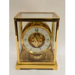 A Jaeger-LeCoultre Atmos clock, gilt and lacquered brass case, no. 540348, 30cm high approx.